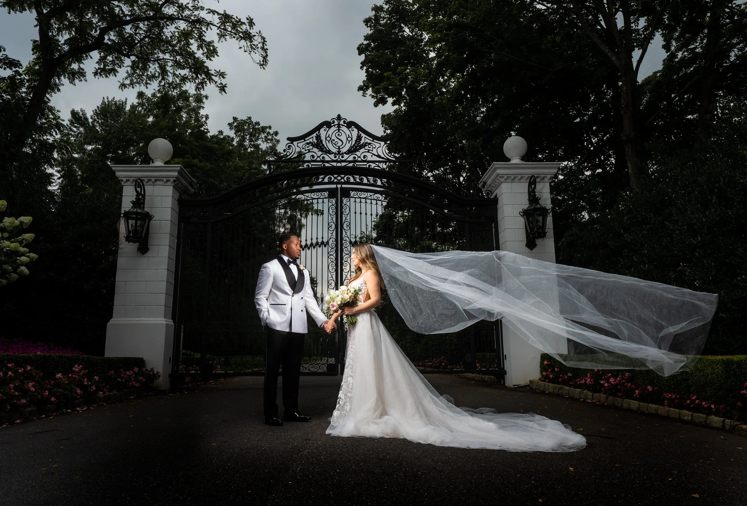 "New Jersey Wedding Photographer" a bride and groom pose in front of a gate at "Shadowbrook at shrewsbury"