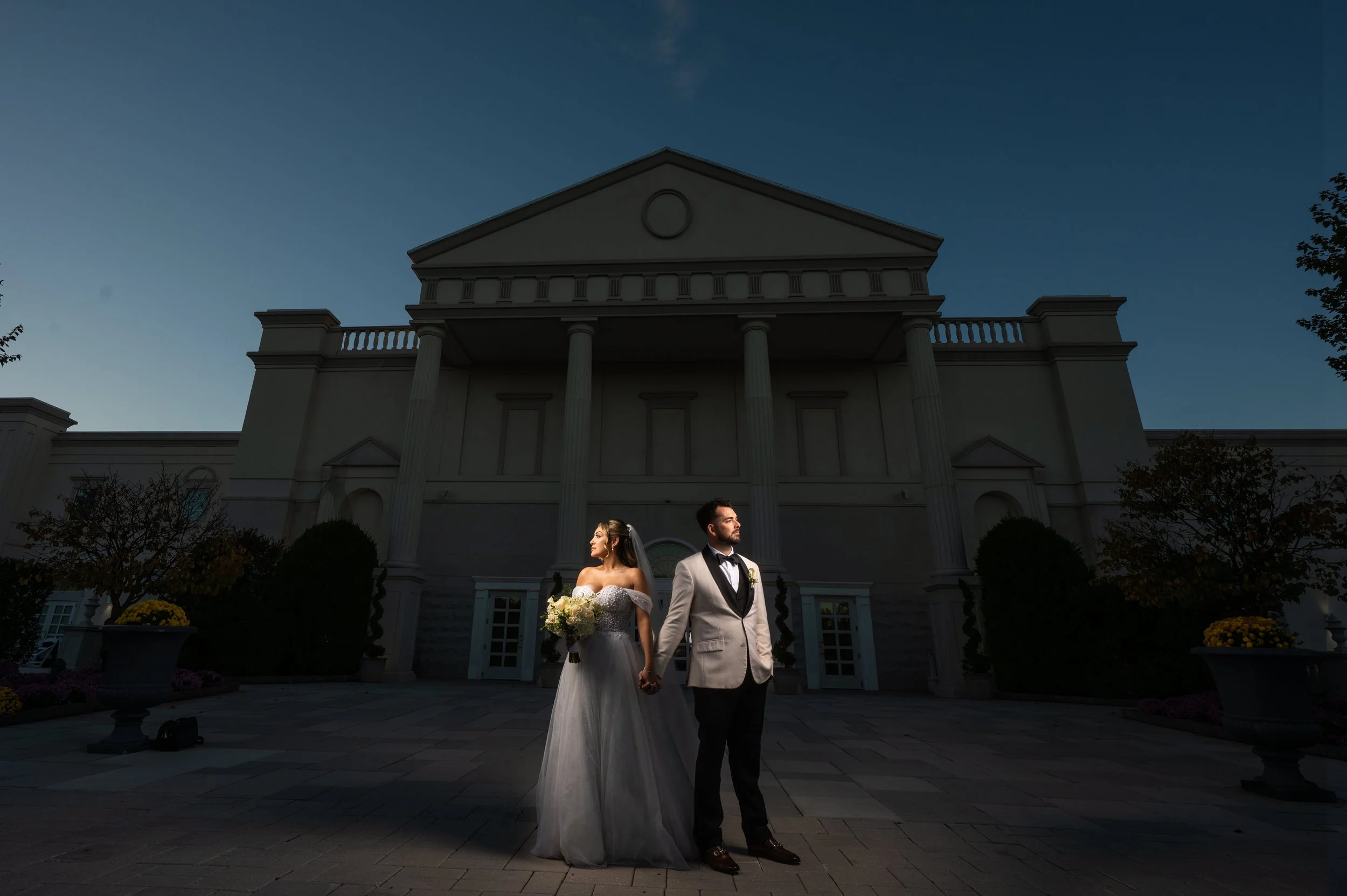 "New Jersey Wedding Photographer" a bride and groom pose in front of "The Palace at somerset Park"
