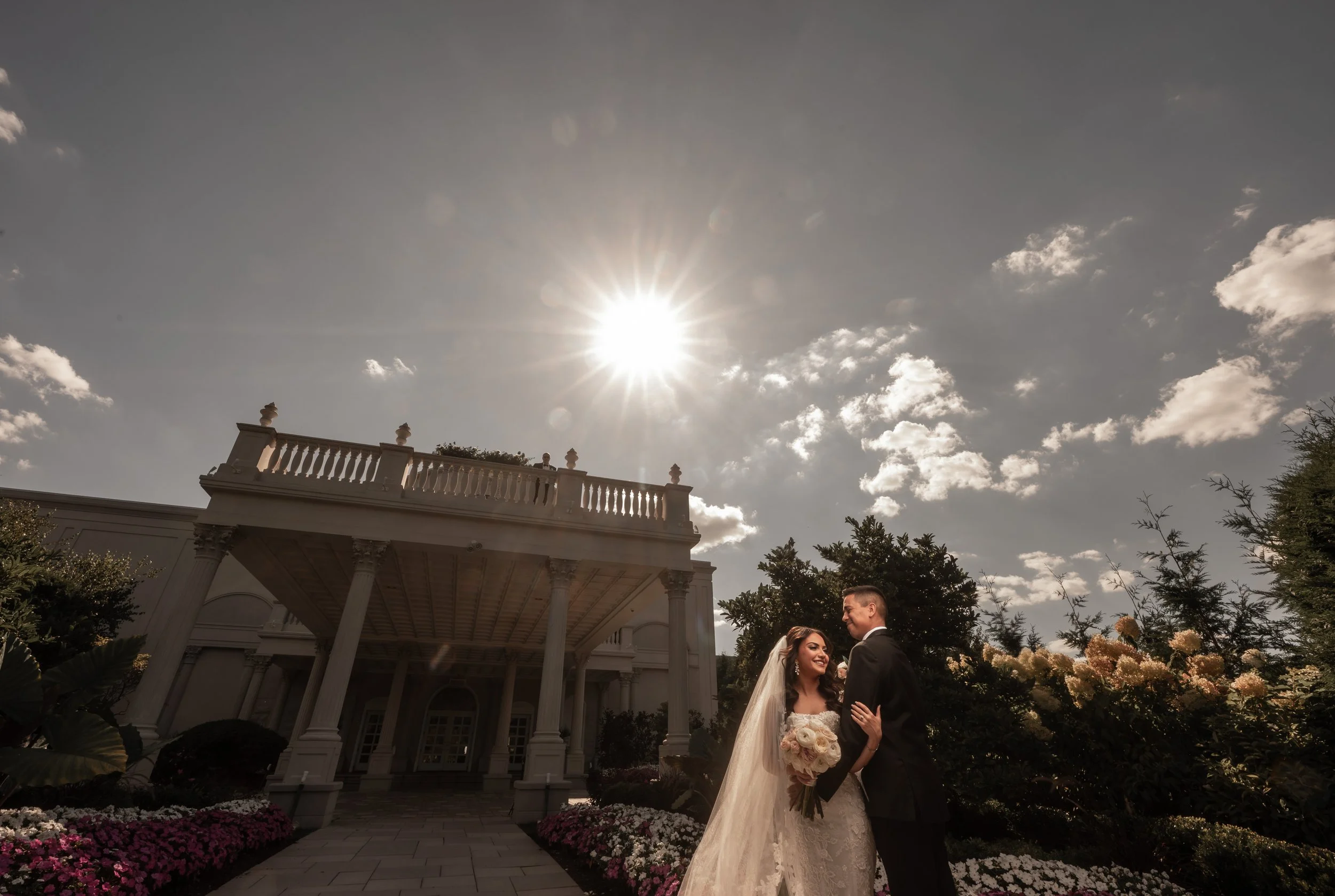 "New Jersey Wedding Photographer" a bride and groom pose in front of "The Palace at Somerset Park"