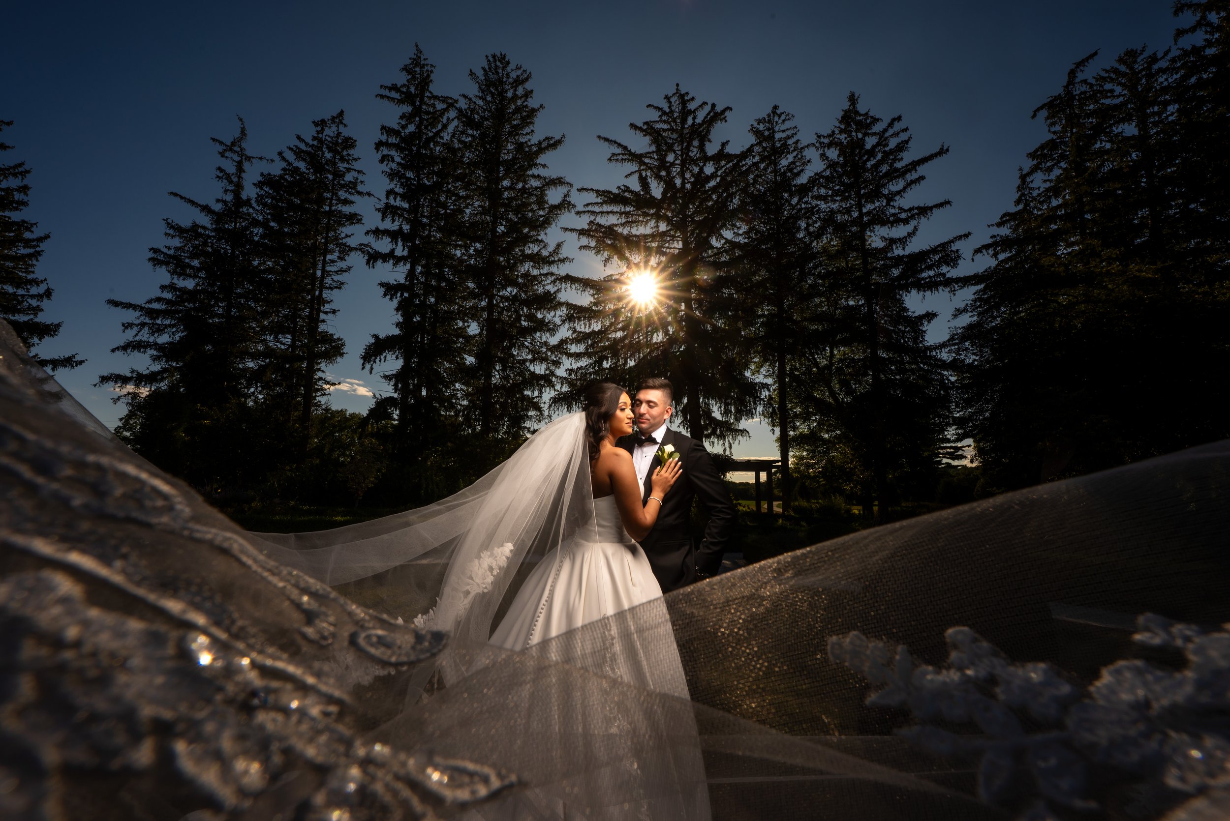 "New Jersey Wedding Photographer" a bride and groom pose for a photo in front of the sun