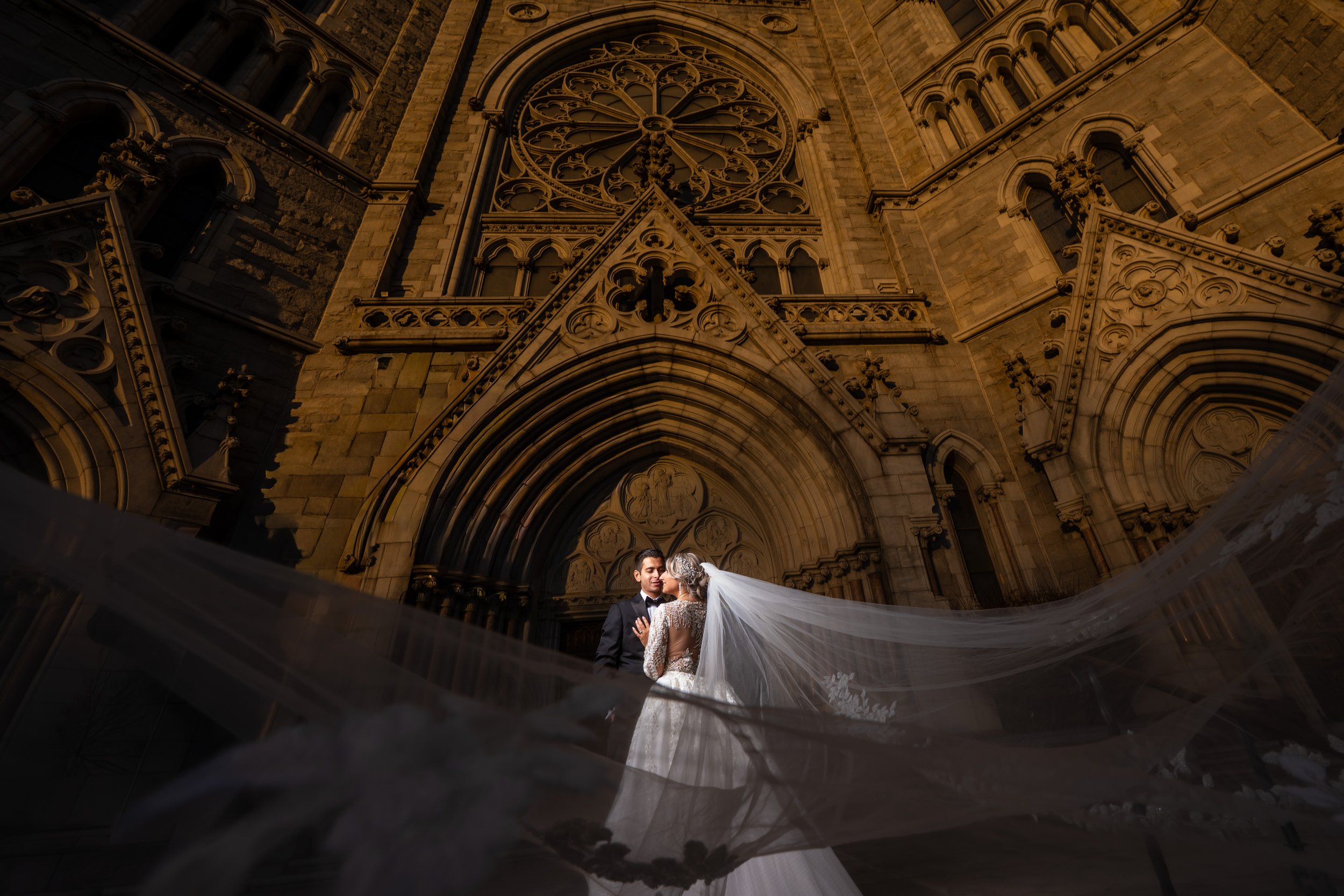 "New Jersey Wedding Photographer" a bride and groom pose in front of a church for a portrait