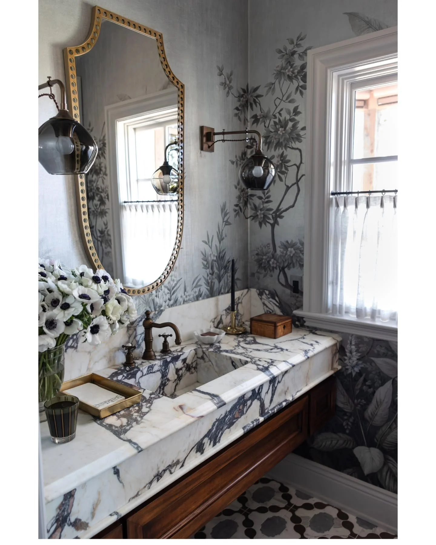 A lot of materials blended together in harmony for this powder room. The floors are made up of wood and 2 different marbles. The wallpaper was the first inspiration and we just kept adding layers.  I'll post the before in stories.  Thank you to every