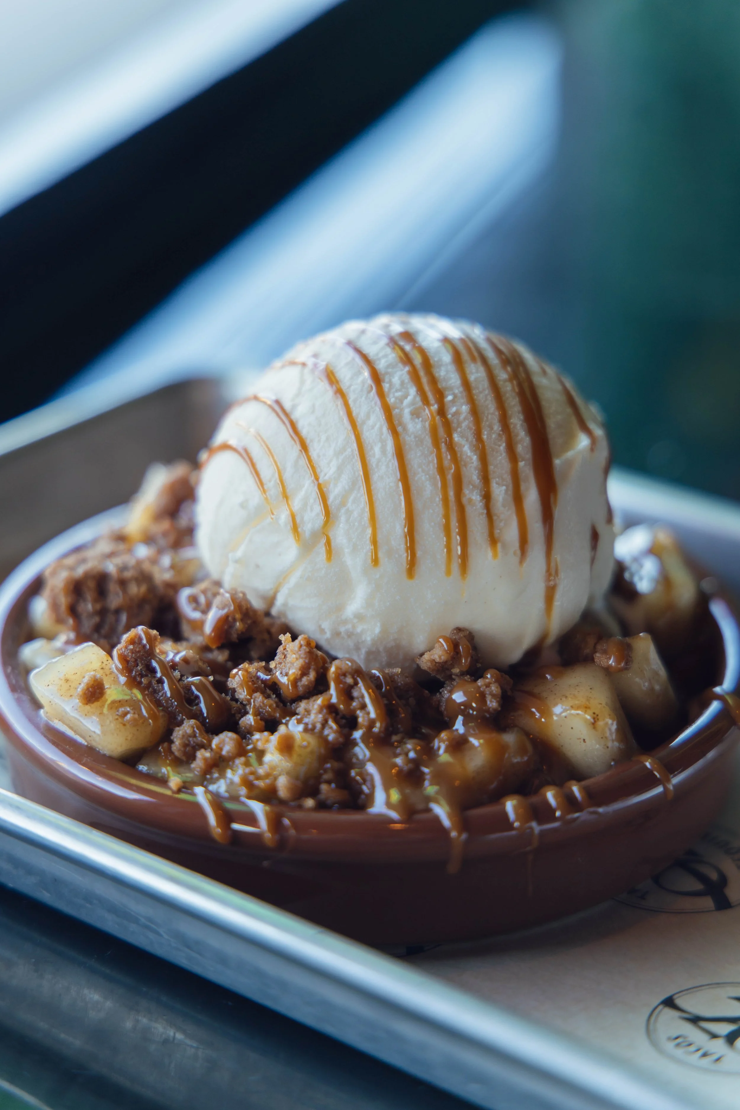 Mexican apple crisp, warm spiced apples, cinnamon streusel, vanilla ice cream, dulce de leche caramel.