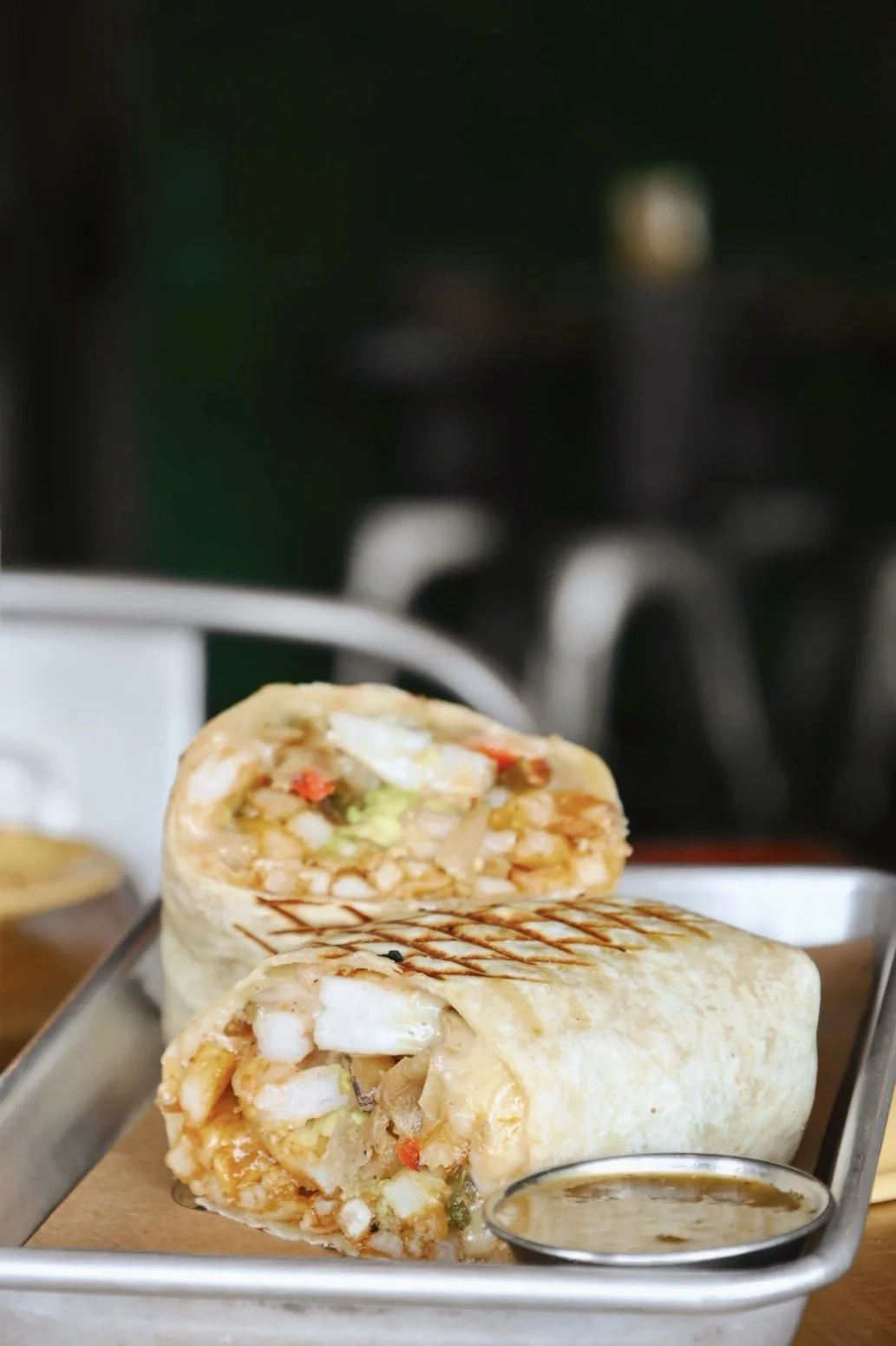 the mermaid burrito, shrimp, sautéed peppers and onions, fries, avocado, jack cheese, chipotle mayo, spicy tomatillo salsa.