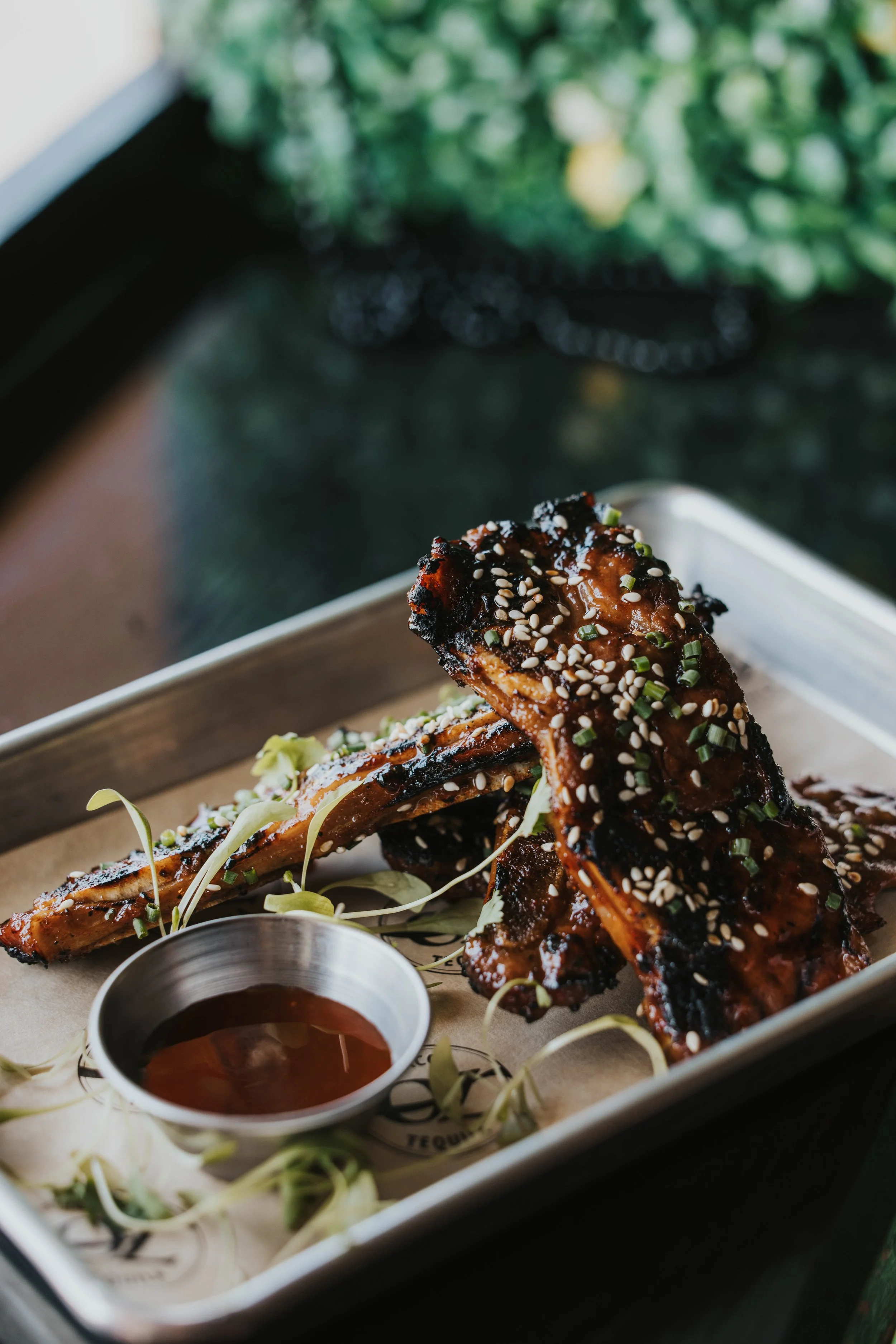 yellow brick ribs, Hawaiian style short ribs, 24hour brown sugar soy marinade, spicy red chili glaze, toasted sesame and chives.