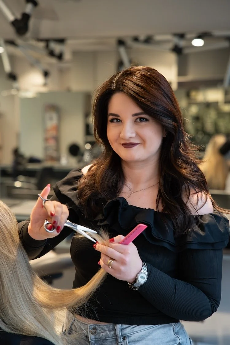 Iuliana frisør i NHC Lyngby er igang med at klippe en kunde