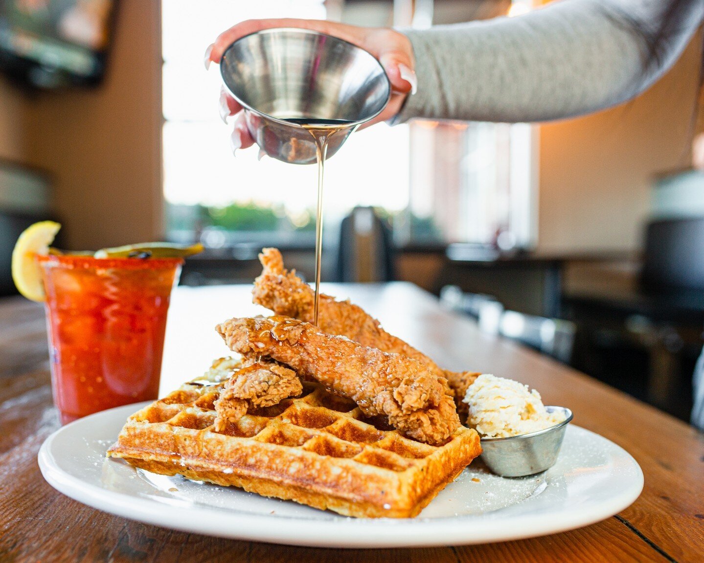 Look at that syrup pour! 🤤 Chicken and Waffles are a brunch must. 

A fluffy house-made waffle is piled high with hand-breaded chicken strips, served with a side of breakfast potatoes, and of course- lots of syrup! 
.
.
. 
#brunch #brunchin #weekend