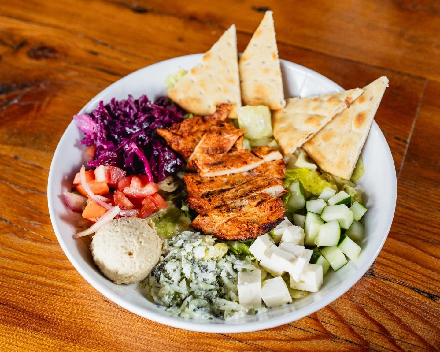 💥 Menu Spotlight 💥

Our Harissa Chicken Bowl has quickly become a local favorite! 

Grilled chicken, hummus, tzatziki sauce, marinated tomatoes and onions, cucumbers, feta cheese, marinated red cabbage, greens, and lemon oil create a delicious gree