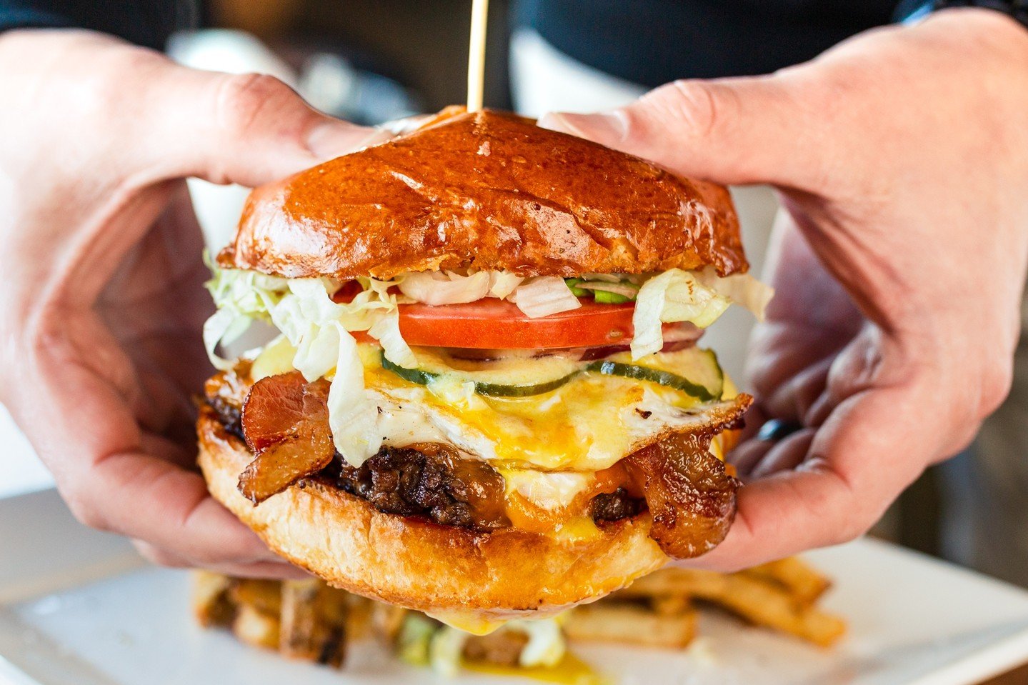 Want a bite?

Our Breakfast Burger is the perfect blend of breakfast and lunch. Our House-Ground Beef Patty is topped with a Fried Egg, Bacon, Sharp Cheddar, Lettuce, Tomato, Onion, House Pickles, Peppercorn Mayo, and Hollandaise all on a delicious b