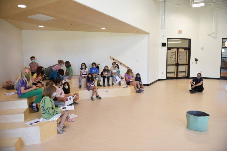  Students gather in the all-school meeting room at the new Greenfield Center School on Wednesday. Staff Photo/Paul Franz 