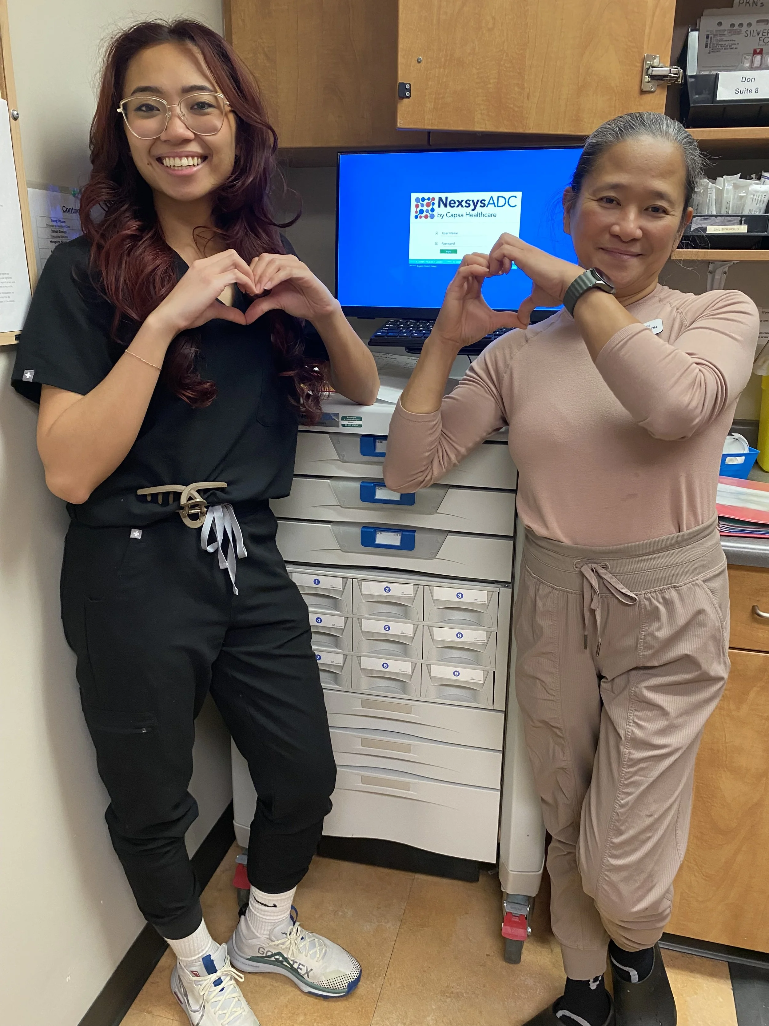 Nurses making hearts with hands