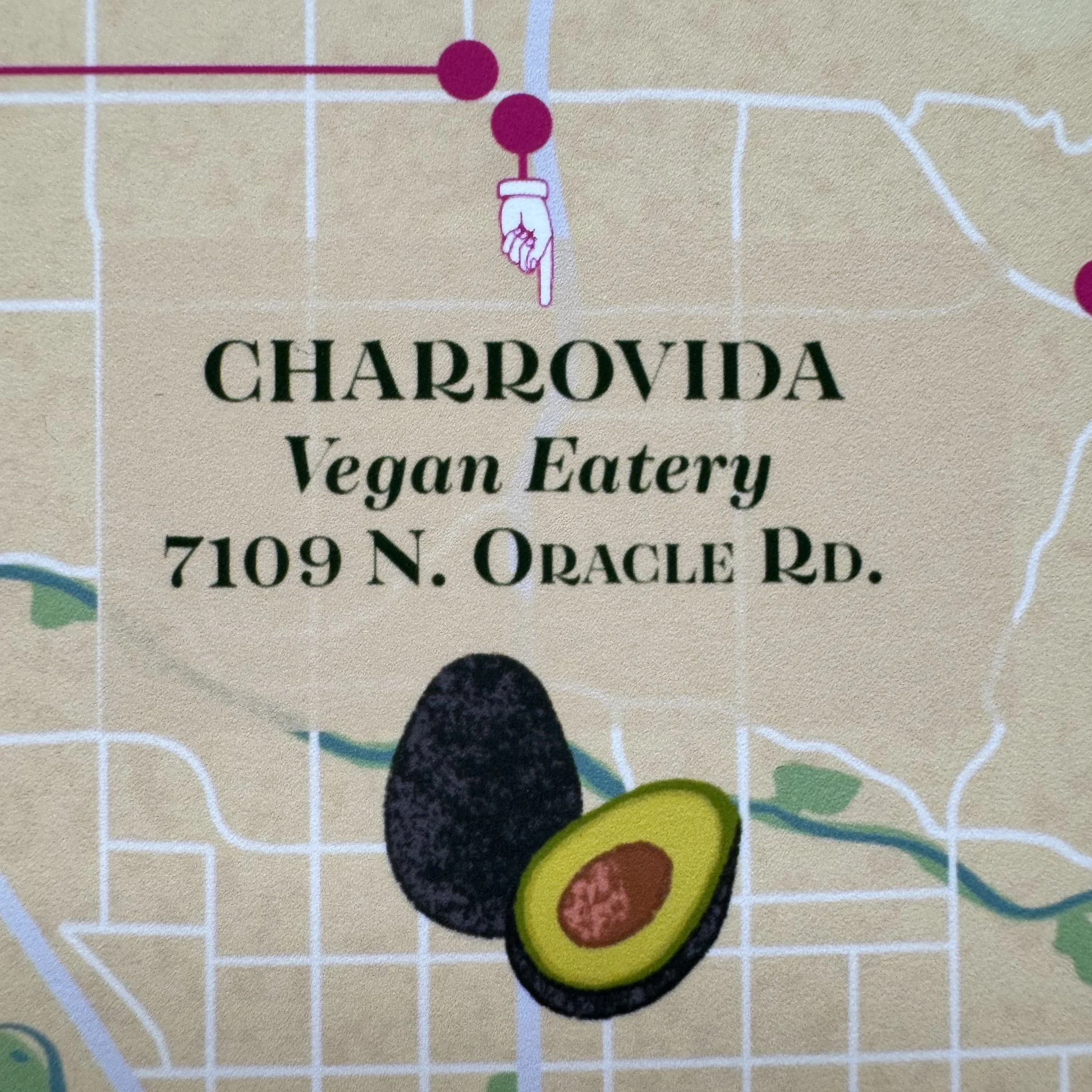 Map with text advertising Charrovida Vegan Eatery at 7109 North Oracle Road, featuring an illustration of an avocado.