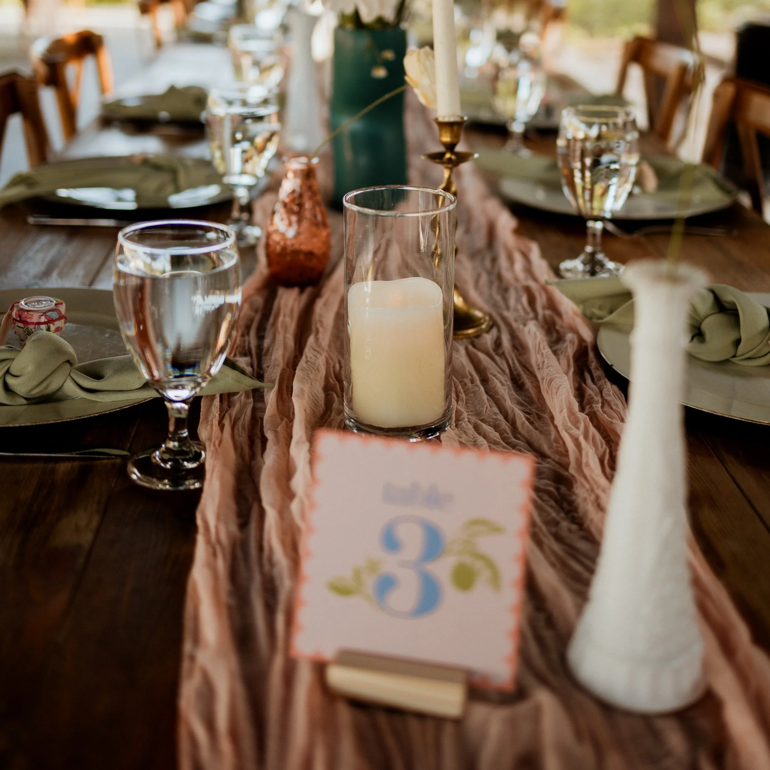 Decorated dining table with candles, glassware, napkins, and a table number card celebrating a 36th birthday.