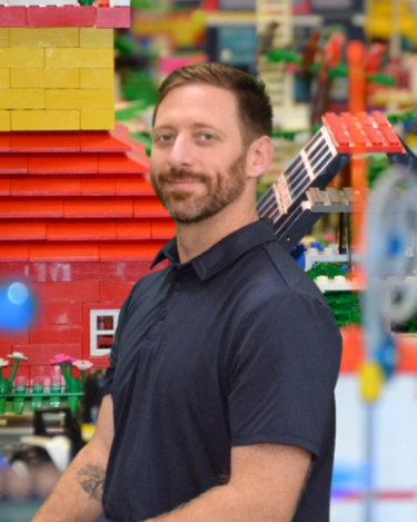 Sam Marion, licensed therapist specializing in autism, ADHD, PDA, and neurodiversity in his therapy office in Buford, Georgia.