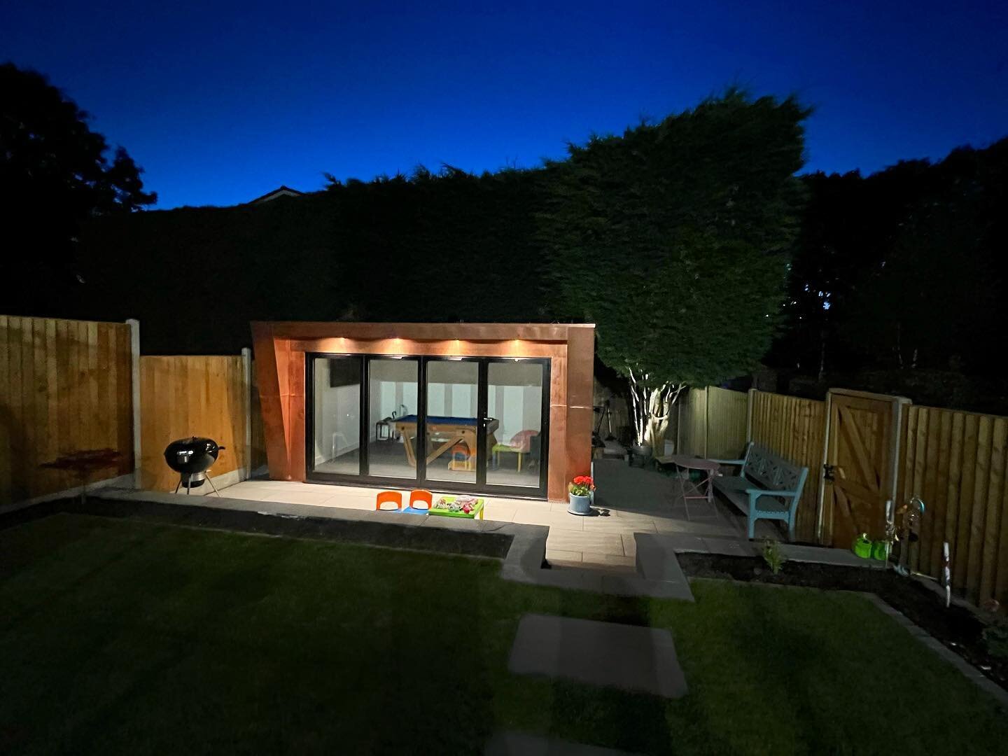 Each one of our builds is individually designed and built, with every element taken into consideration. This picture is a nice example of lighting design, incorporating flush down lights into the soffit to illuminate the front of the building along w