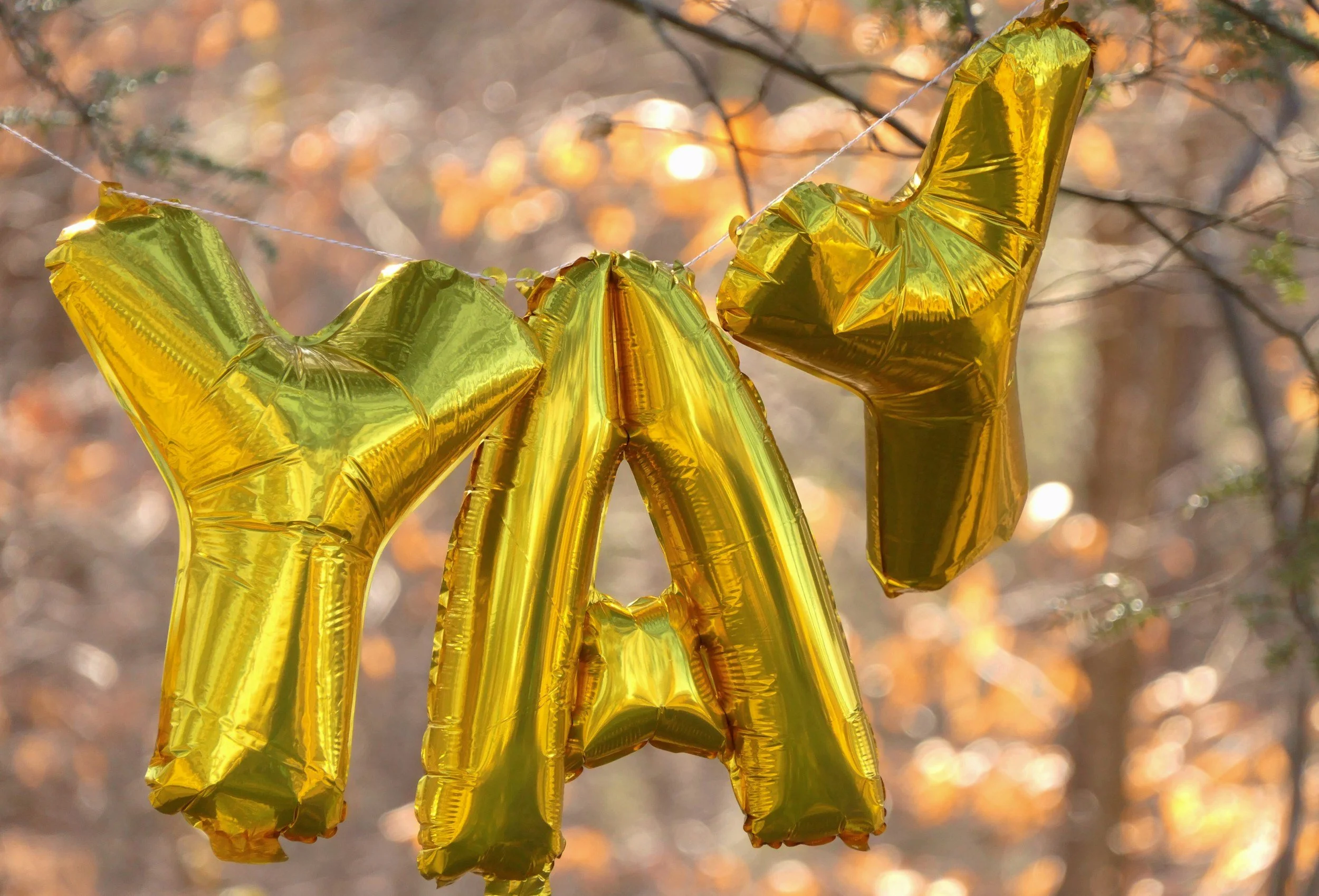 Gold balloons spelling out 'YAY'