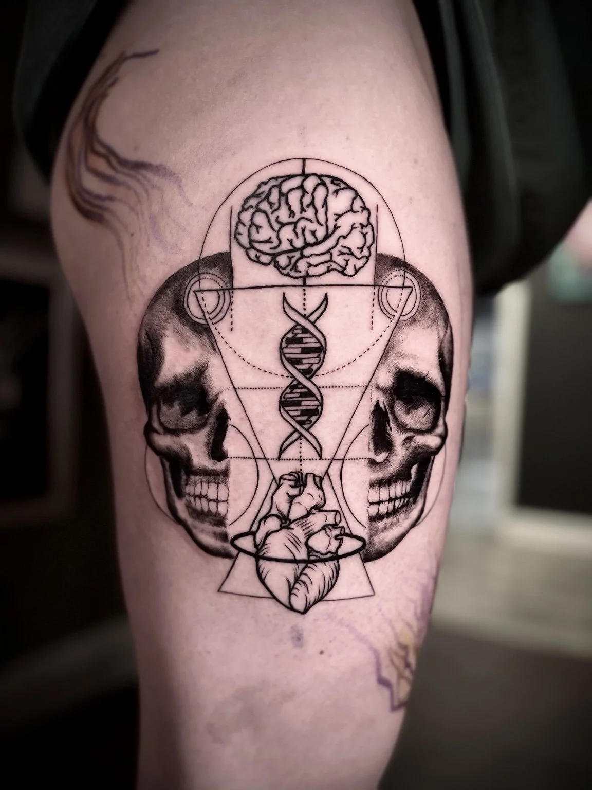 Geometric skulls, DNA, brain, and heart tattoo by Andrew Tanner