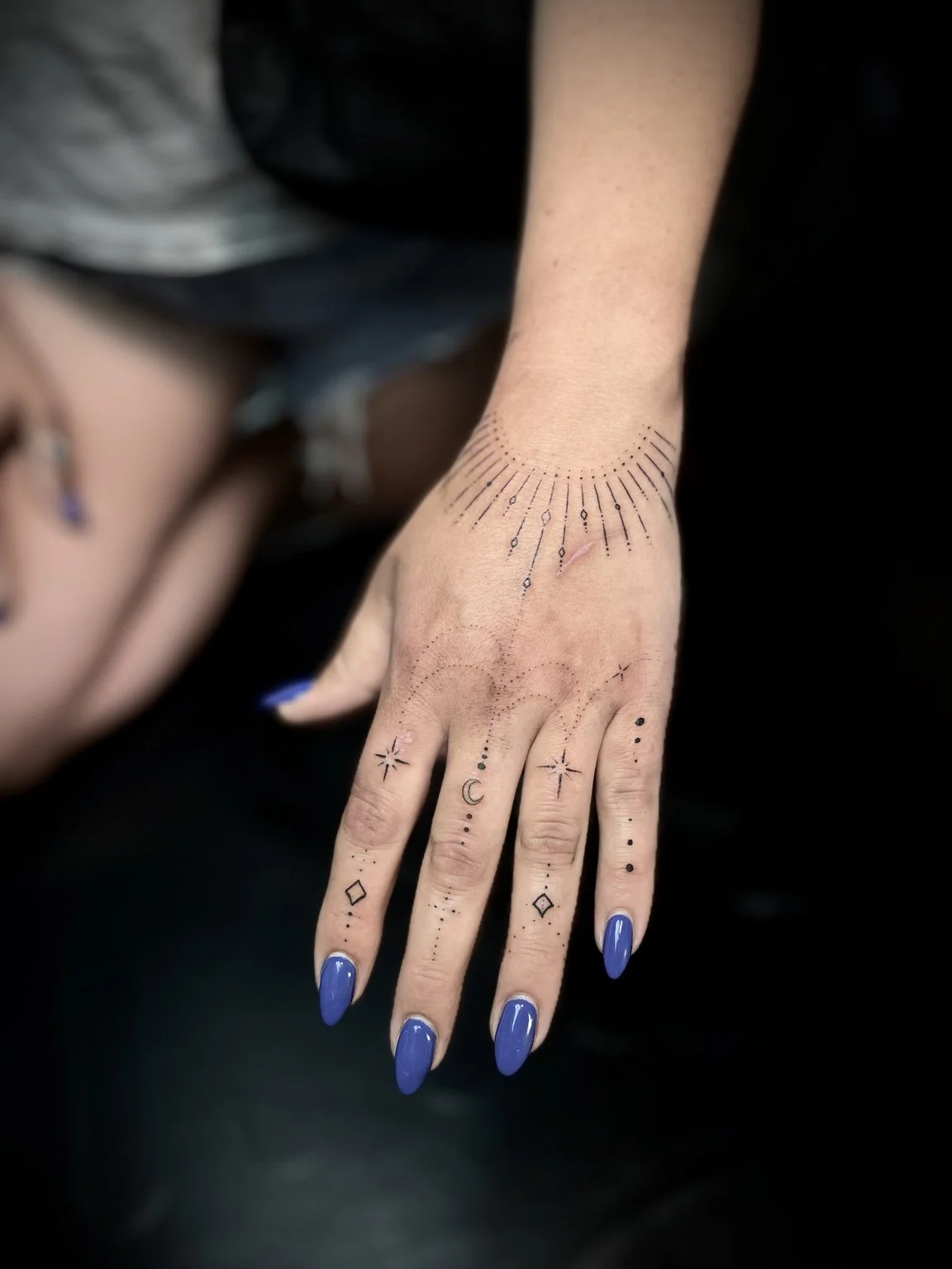 Fine-line celestial hand tattoos by Andrew Tanner