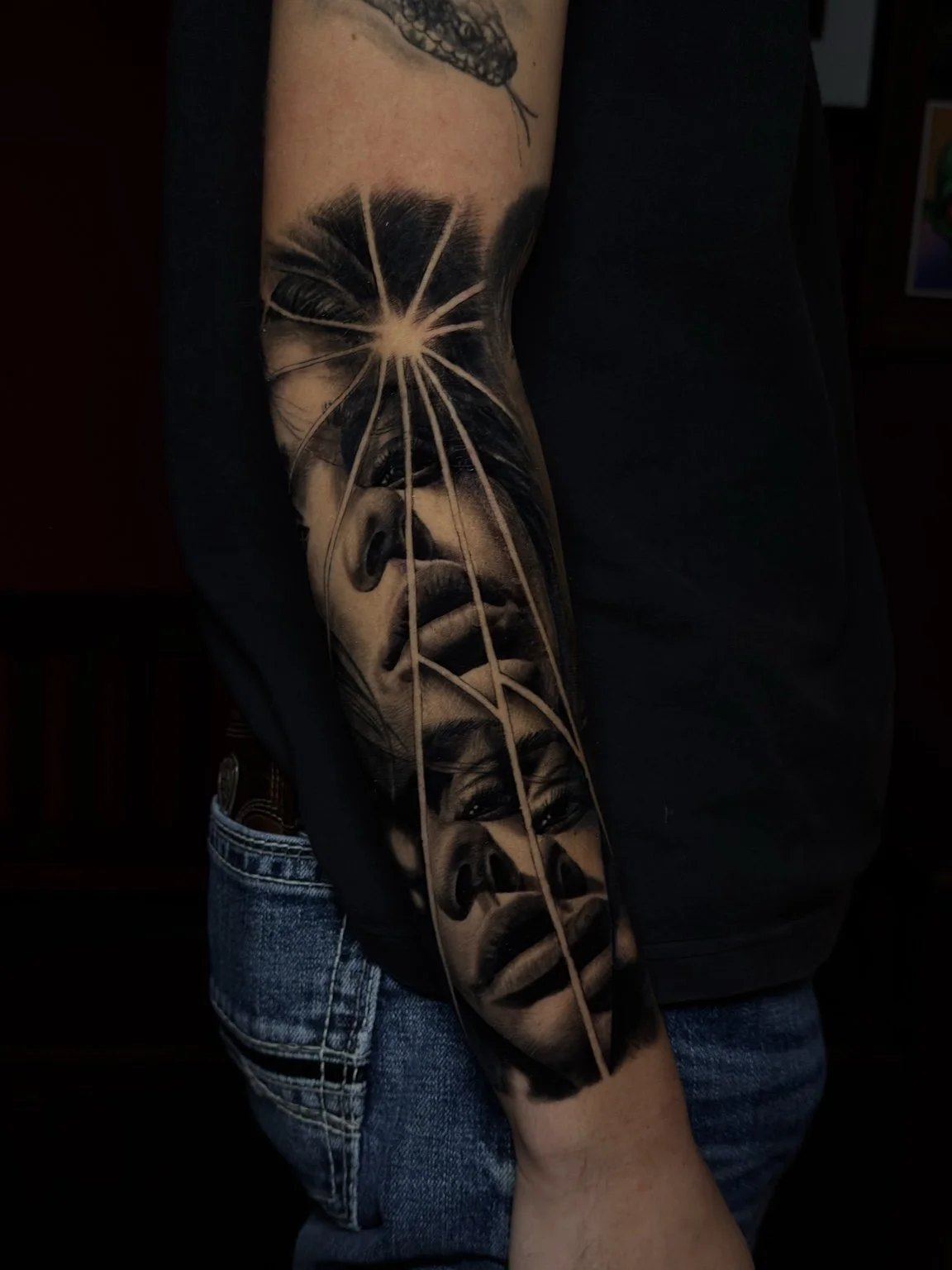 Black-and-grey fractured portrait forearm tattoo by Scott Flanders