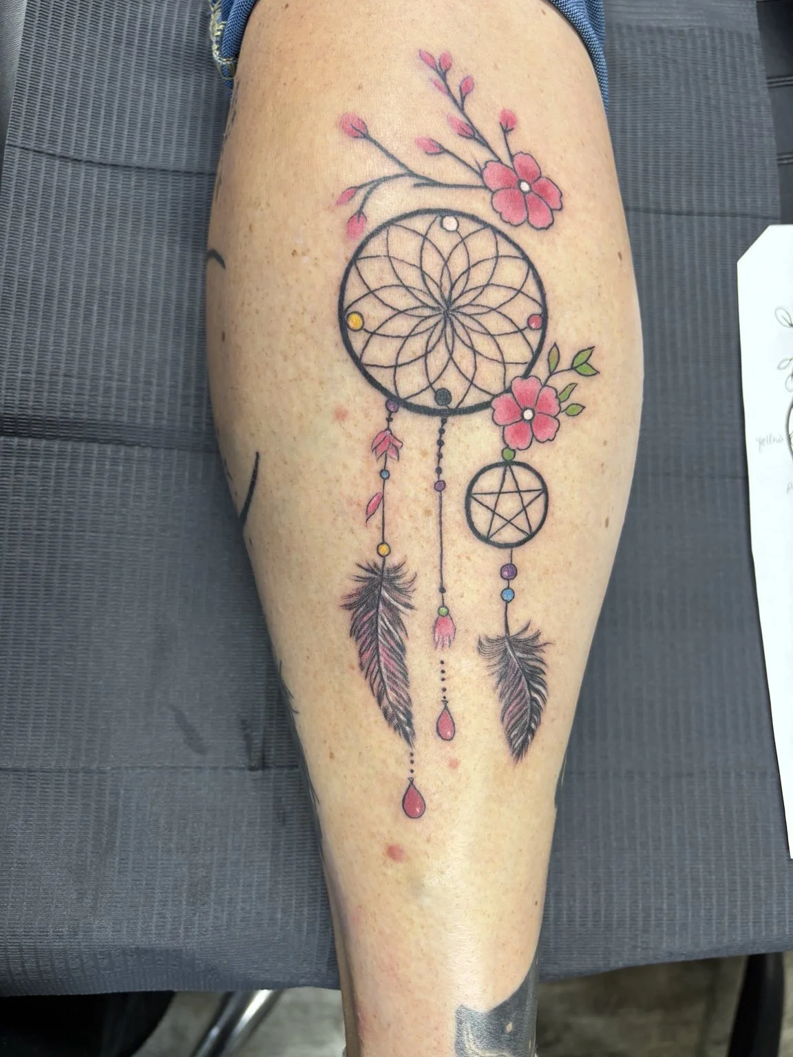 Color floral dreamcatcher tattoo by Anna Small