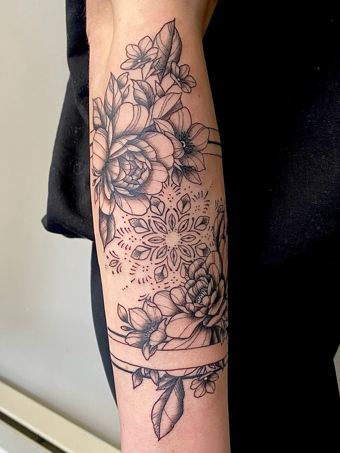Flowers and mandala forearm tattoo by Liz House