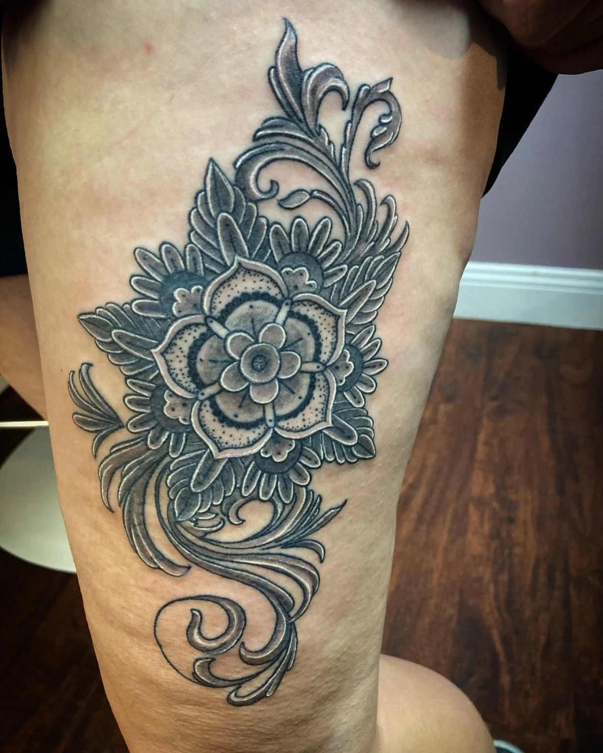 Black-and-grey ornamental floral tattoo by Anna Small