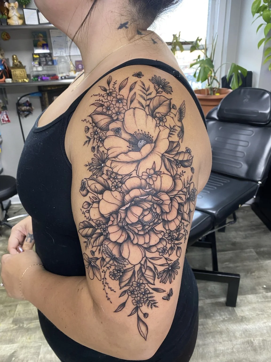 Detailed floral shoulder and upper-arm tattoo by Liz House