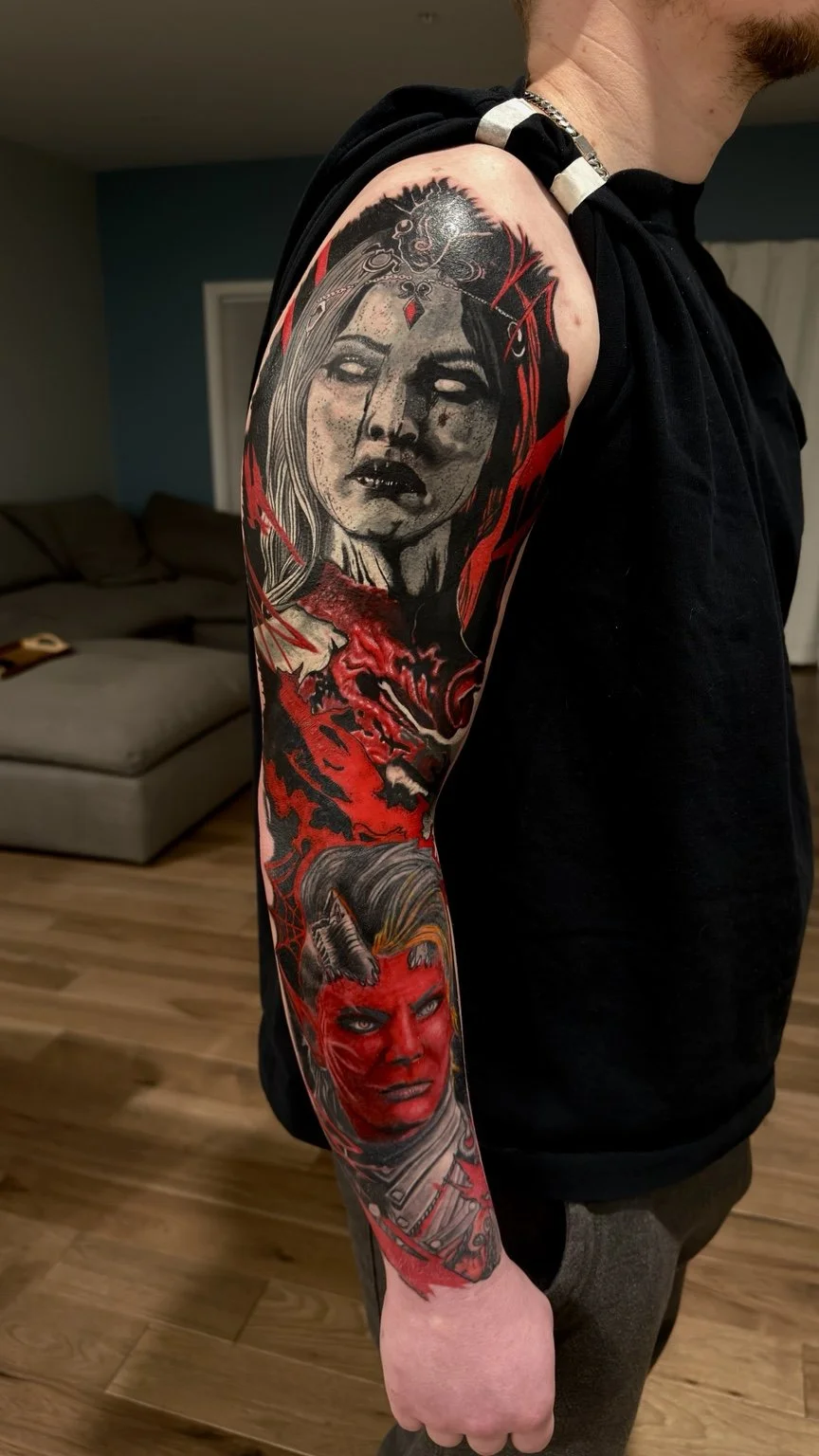 Red and black fantasy character sleeve tattoo by Damian Marinelli