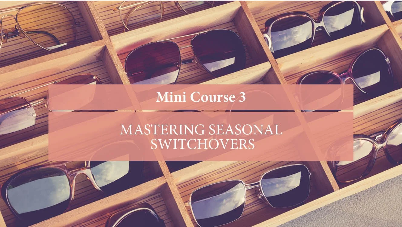 A display case with multiple pairs of sunglasses in wooden compartments.