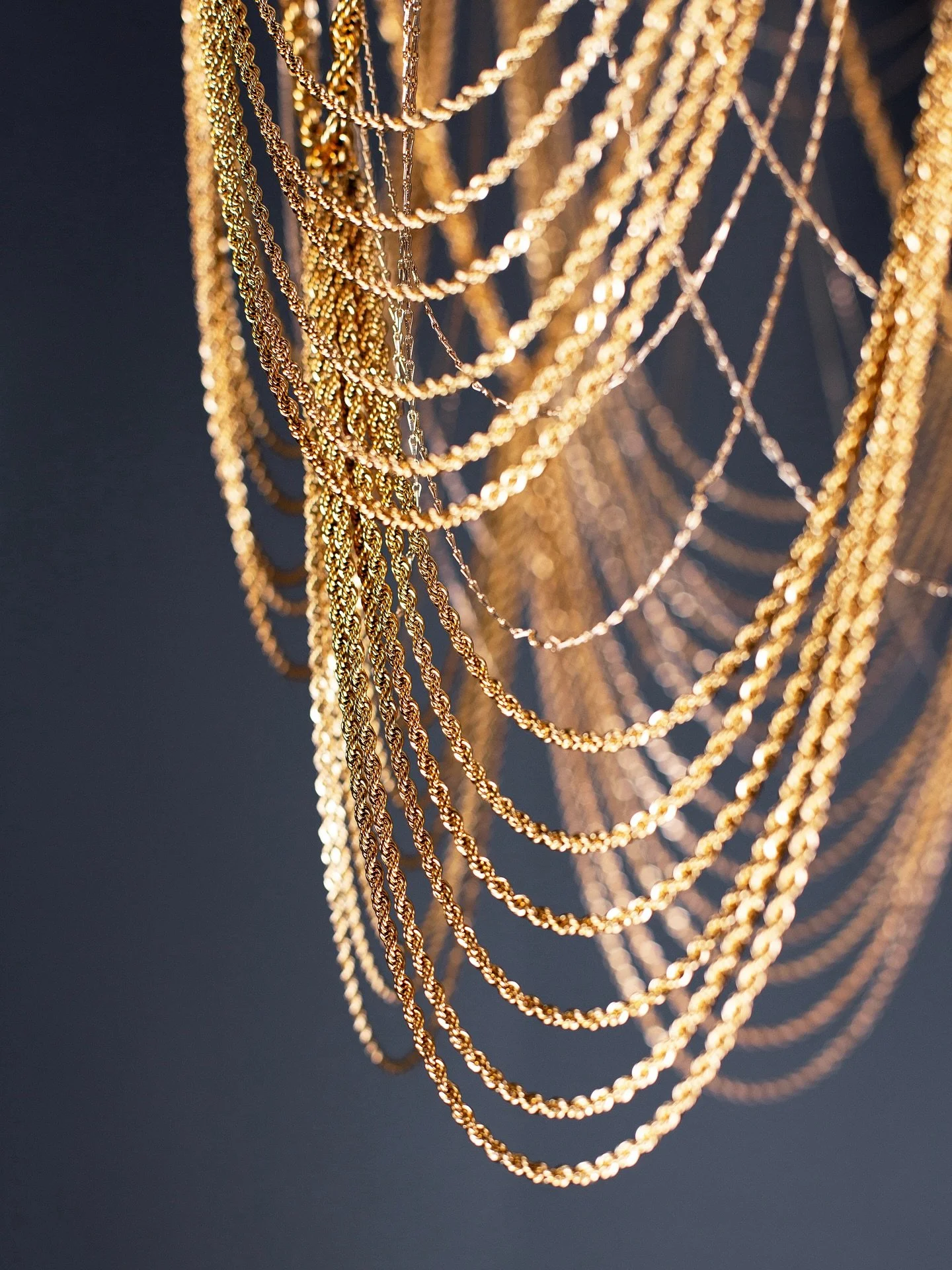 &ldquo;The Hustler&rdquo; opens the collection, draped in gold rope chain that scallops like layered necklaces. It glitters with the swagger of Darryl Dawkins and the rise of hip hop&rsquo;s love of gold as status. A net that is both chandelier and c