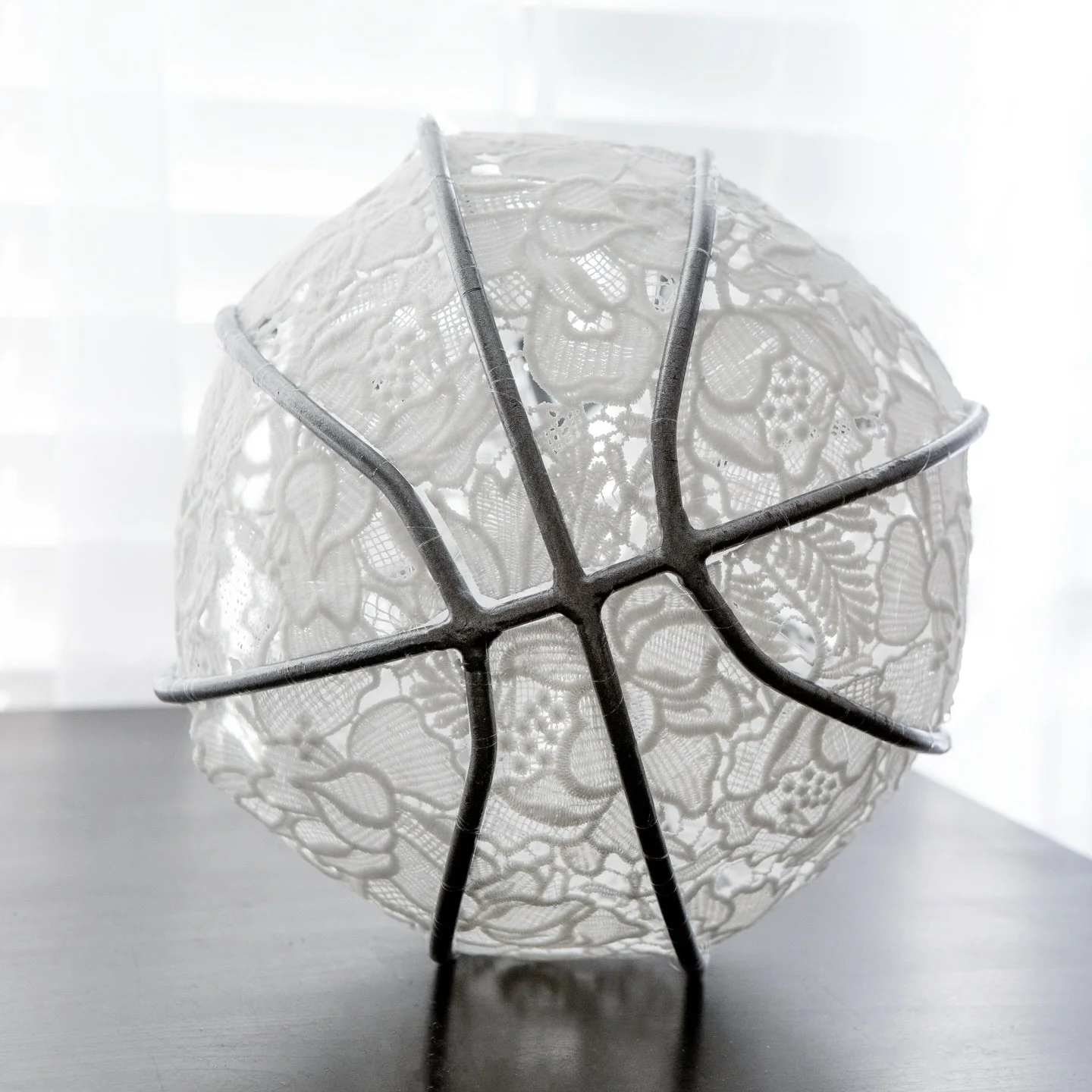 Soft doesn&rsquo;t mean weak. Lace Ball holds delicacy inside the discipline of the game. 

A sculptural basketball exploring contrast, softness contained within structure. Constructed with guipure lace and bound by steel, this piece lives between te
