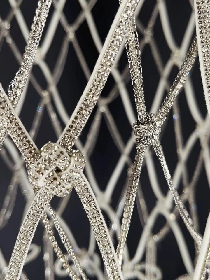 The tension of a perfectly tied bow. 🎀⛓️

The Suit carries the quiet pressure of a league that decided how athletes were allowed to look.

Every chain is placed by hand, like tailoring, referencing the era when image became regulation. The knots and