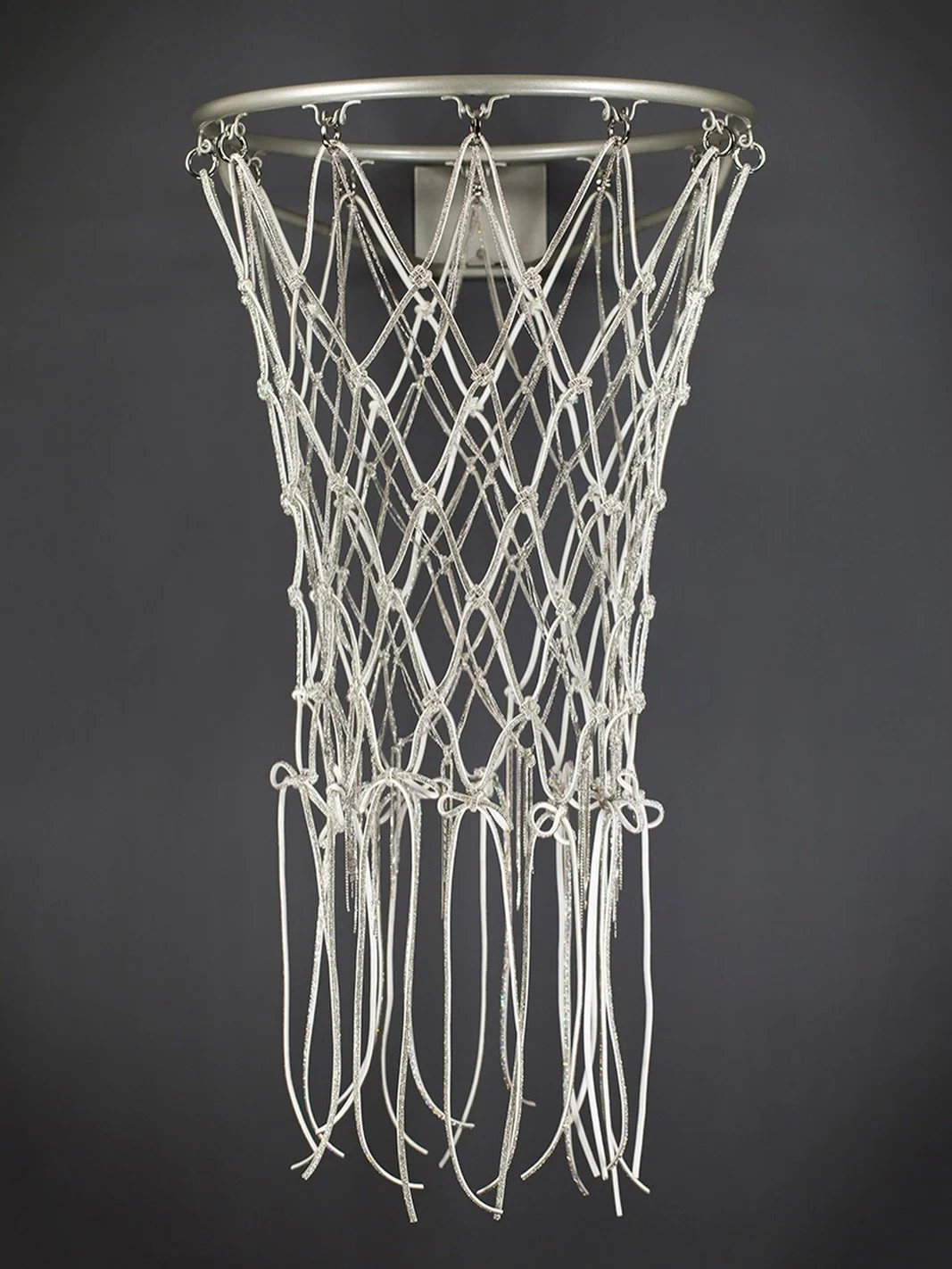 The Suit follows in tailored precision, bows binding the net into formality. It recalls the Michael Jordan era, when appearance was codified, disciplined, and dressed in suits that embodied professionalism and restraint.

This is an heirloom-quality 