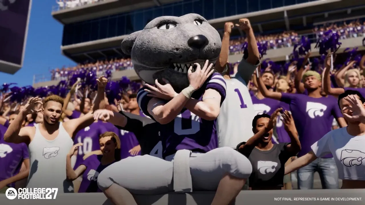 EA Sports College Football gameplay screenshot featuring the Kansas State mascot, Willie the Wildcat, posing in front of a cheering stadium crowd wearing purple and white team colors.