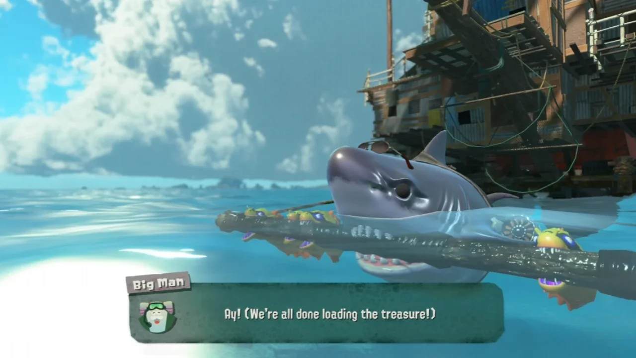 Gameplay screenshot from Splatoon Raiders showing a large shark and Smallfrys in the ocean near a wooden base with a dialogue box from Big Man.
