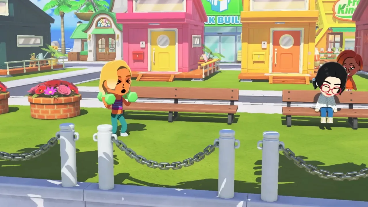 A blonde Mii character lifts green dumbbells while another character sits on a park bench in the vibrant town square of Tomodachi Life: Living the Dream.