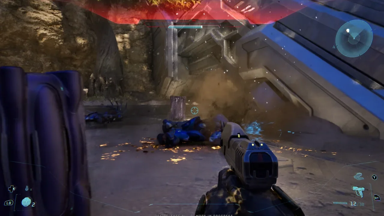 First-person gameplay from Halo Campaign Evolved showing a player holding a Magnum pistol after defeating an Elite near a metallic Forerunner structure.
