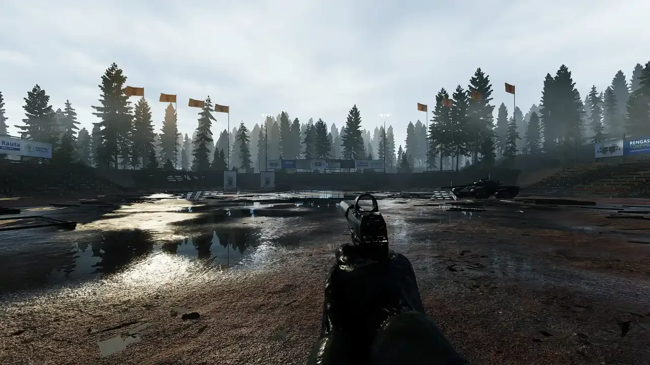 A first-person perspective gameplay screenshot of Road to Vostok featuring a suppressed handgun aimed across a muddy, flooded outdoor arena surrounded by a dense pine forest.