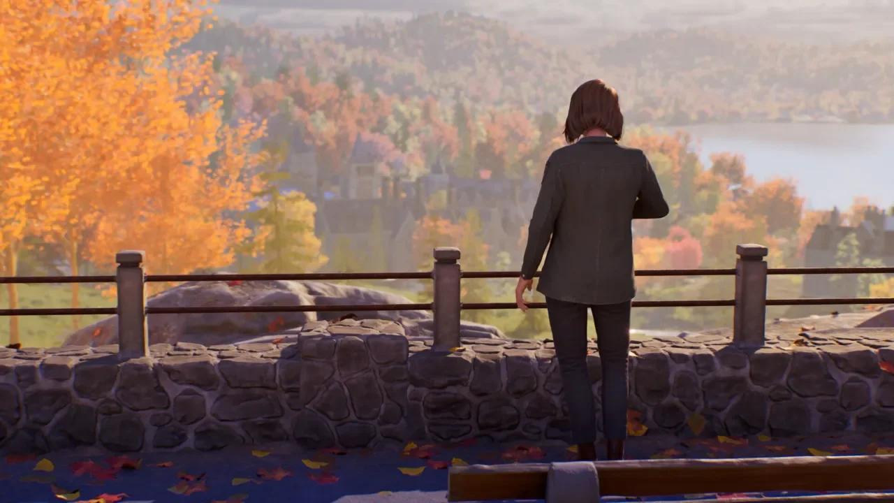 Max Caulfield overlooks a scenic autumn valley with vibrant orange trees and a distant lake from a stone overlook in Life is Strange: Reunion.