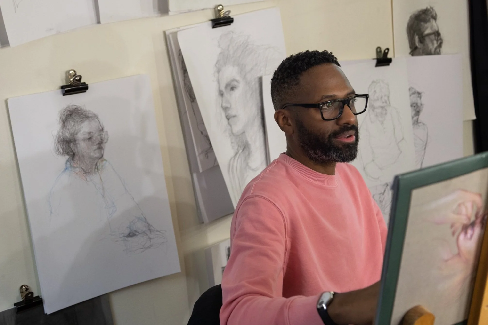 British artist Curtis Holder drawing at the National Theatre during his artist residency