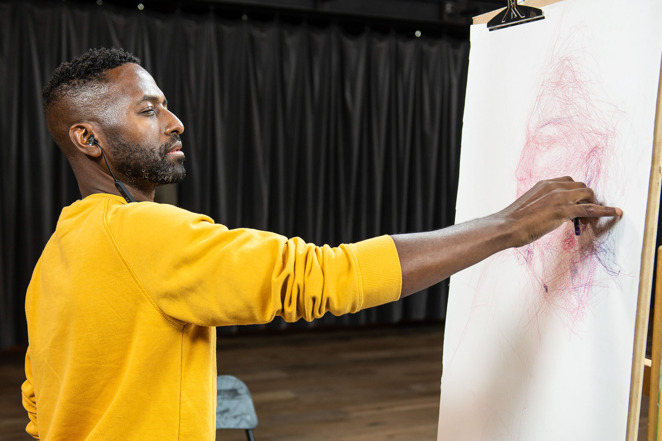 Close up of Curtis Holder drawing drag queen The Vivienne at Battersea Arts Centre during Heat 2 of Portrait Artist of the Year, Series 7