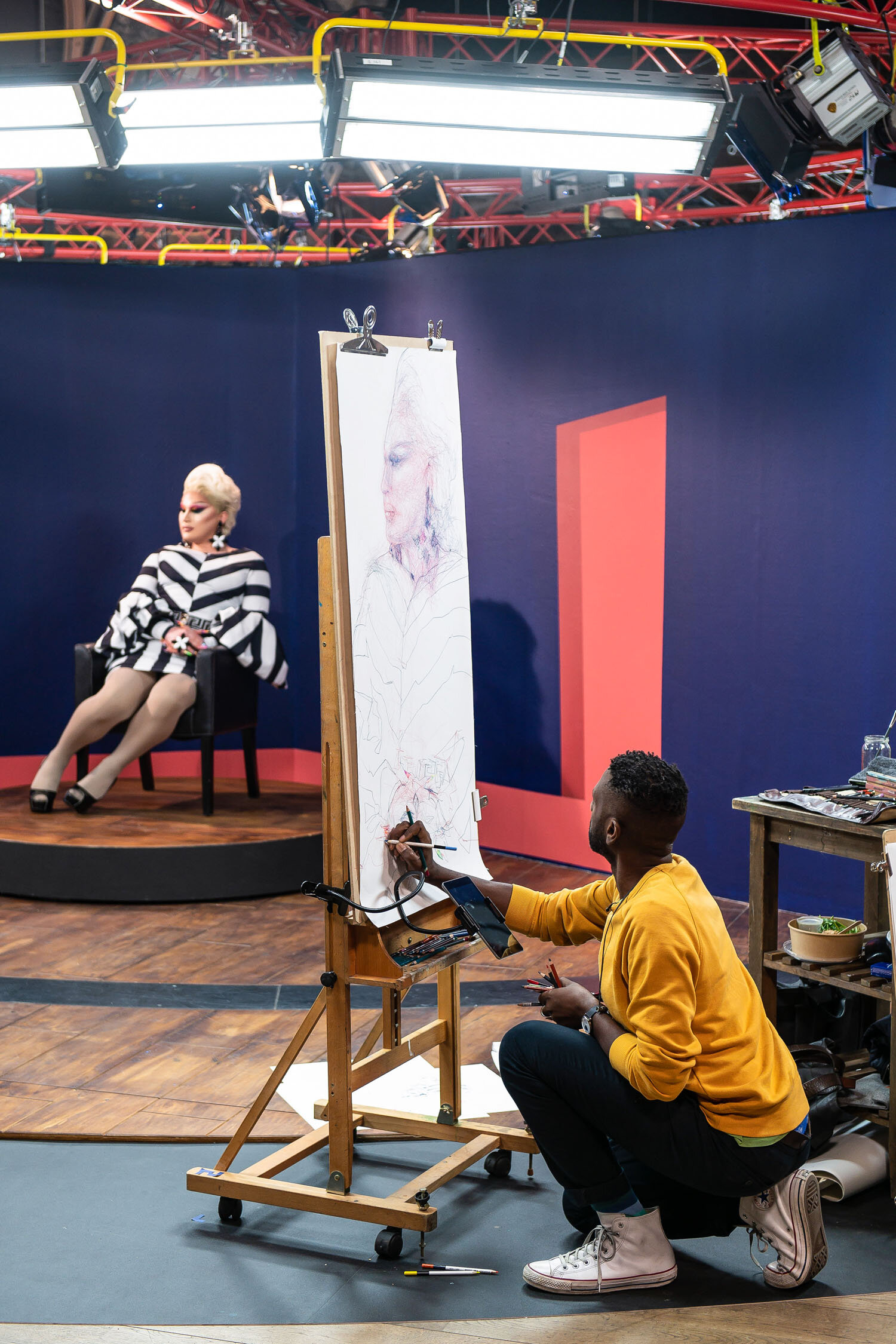 Curtis Holder drawing The Vivienne, winner of Ru Paul's Drag Race UK at Battersea Arts Centre during Heat 2 of Portrait Artist of the Year, Series 7