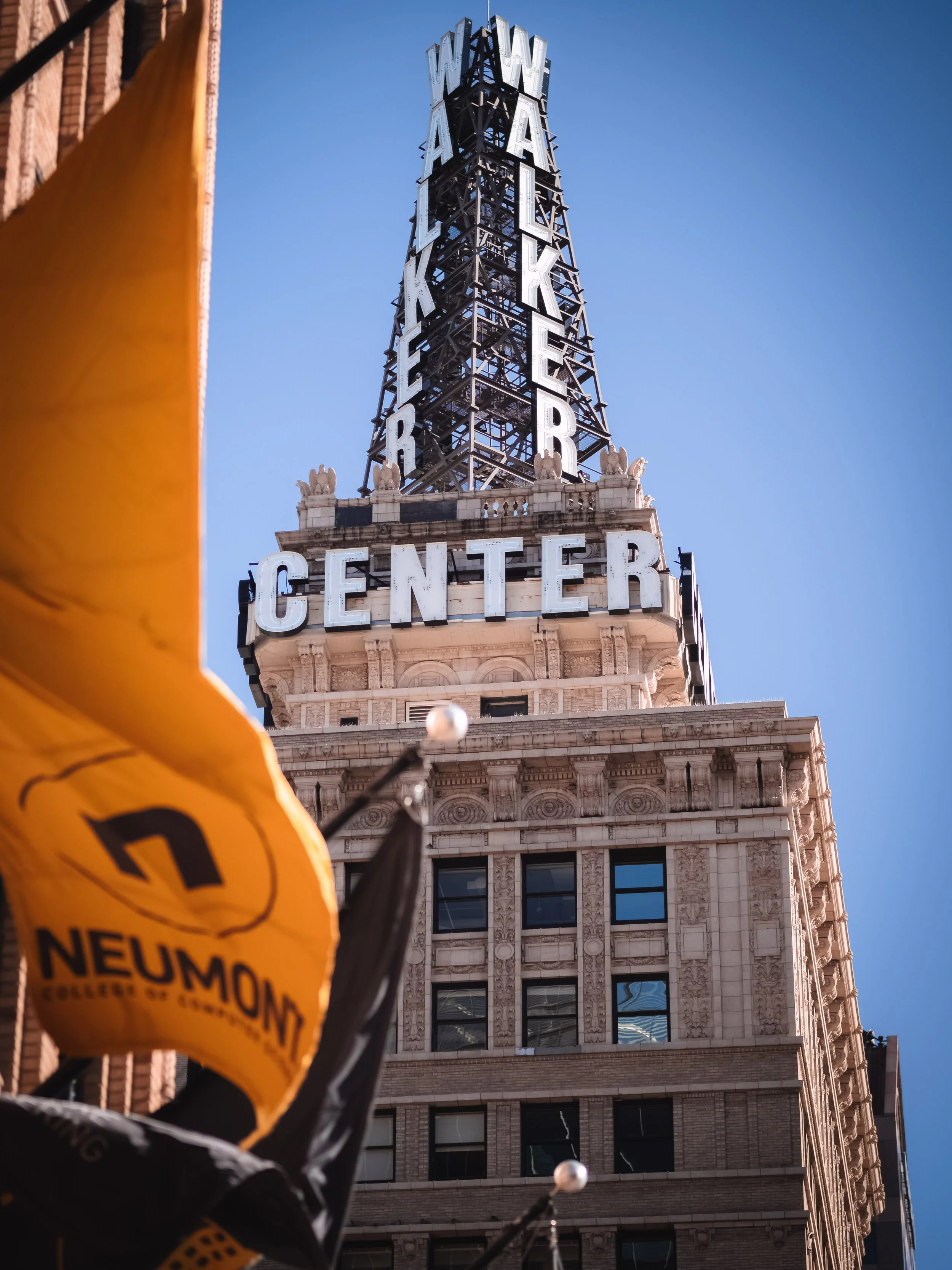Walker Center building with Neumont College flags in the foreground in Salt Lake City Utah