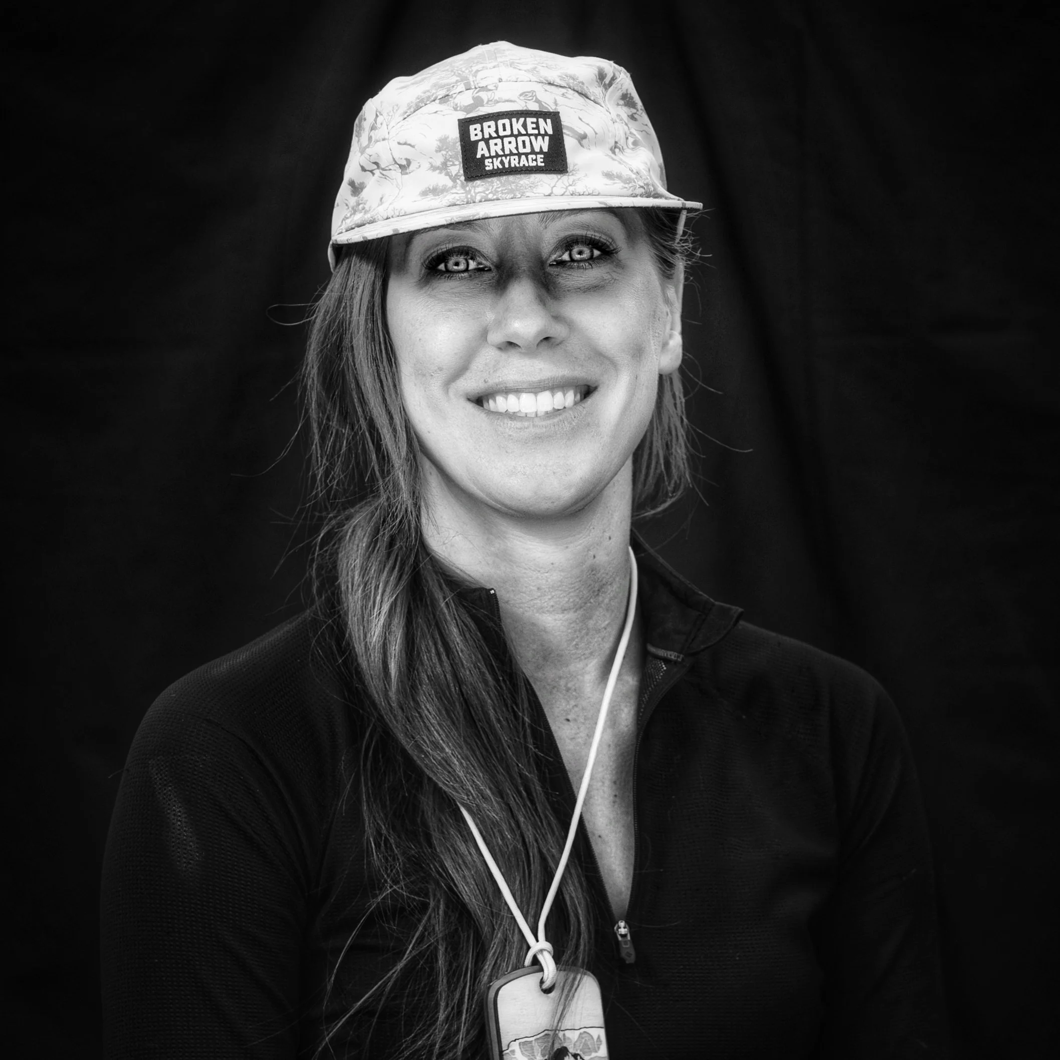 Black and white portrait of Kelly Fuson wearing a Broken Arrow cap and medal