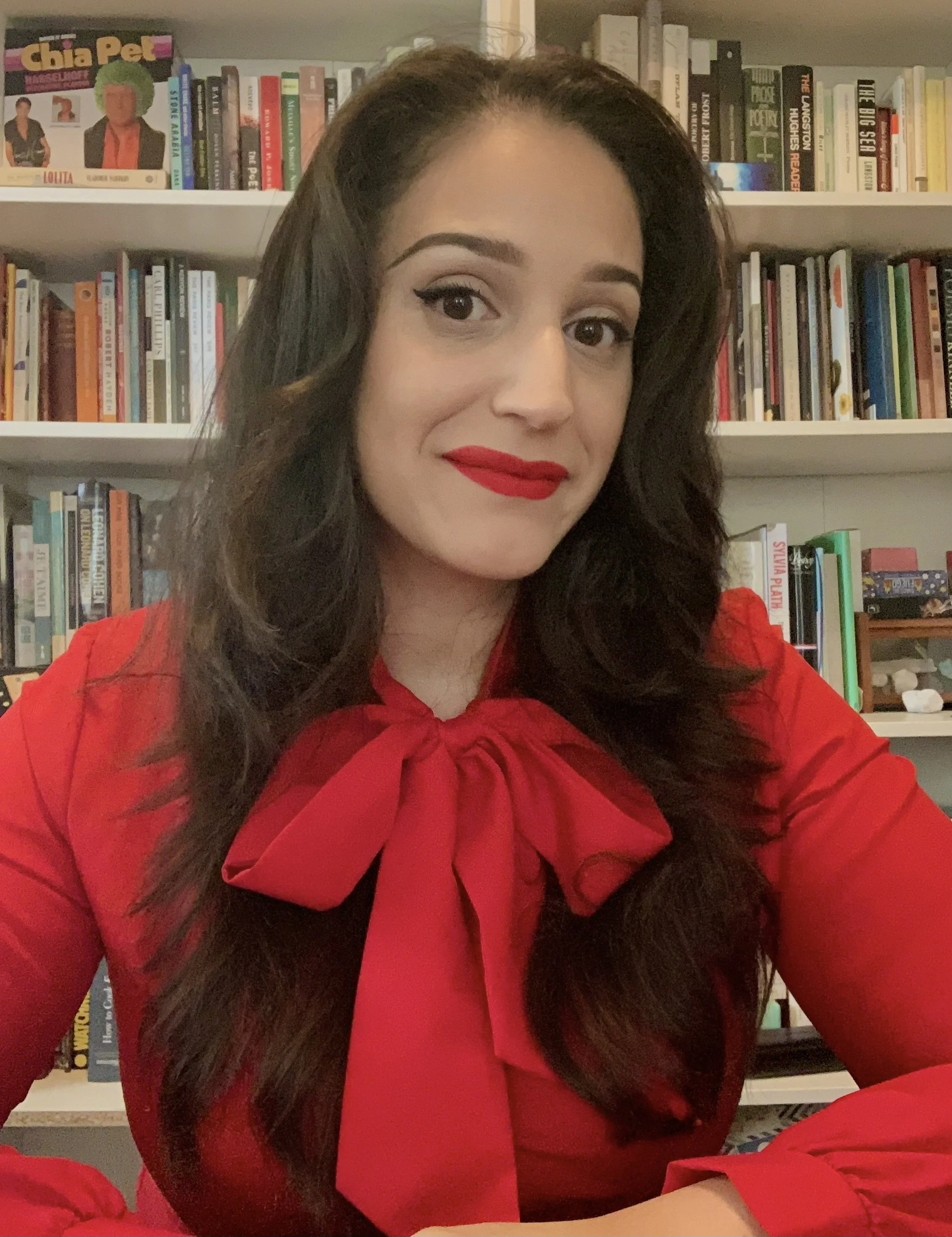 Daphne Maysonet sitting in front of a beige bookshelf.