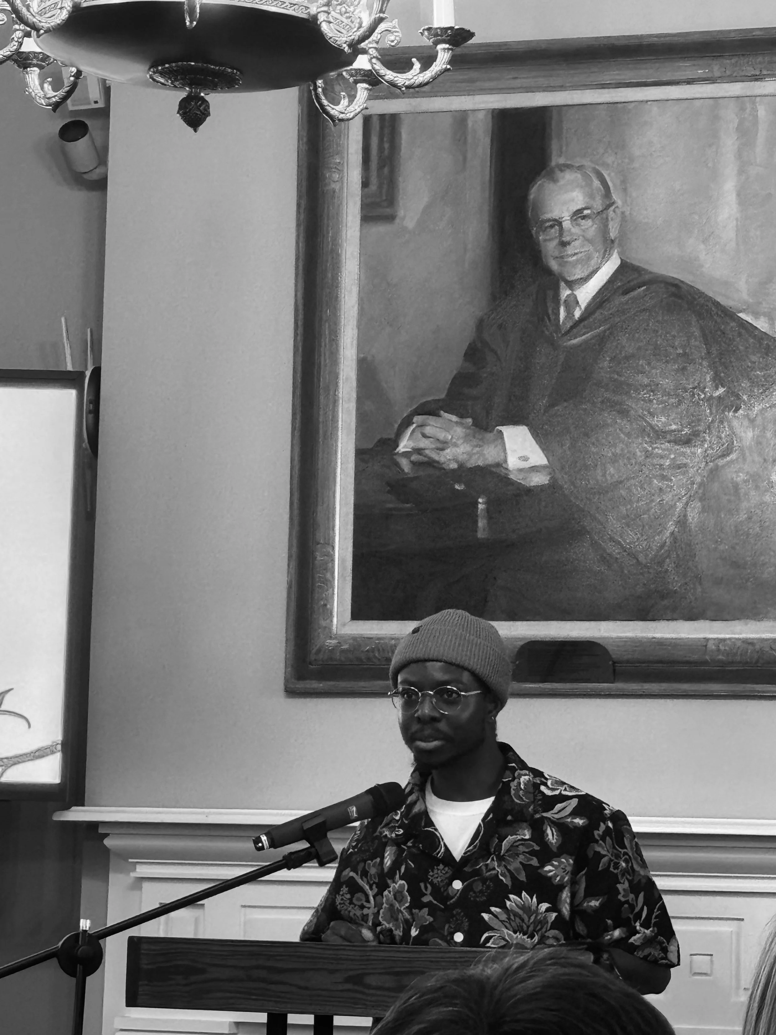 O-Jeremiah Agabaakin standing at a microphone.