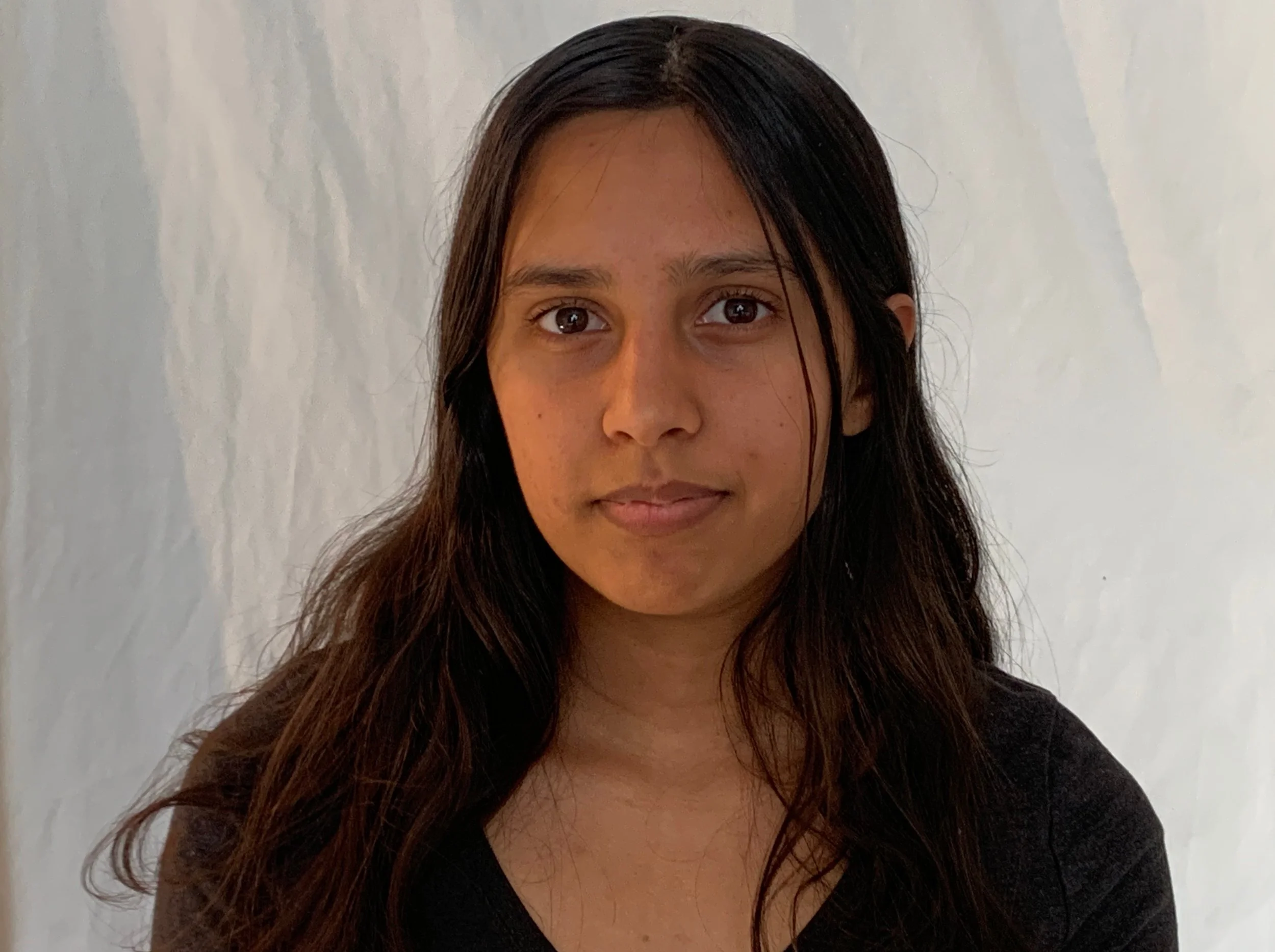 Alex Chand standing in front of an ivory wall.