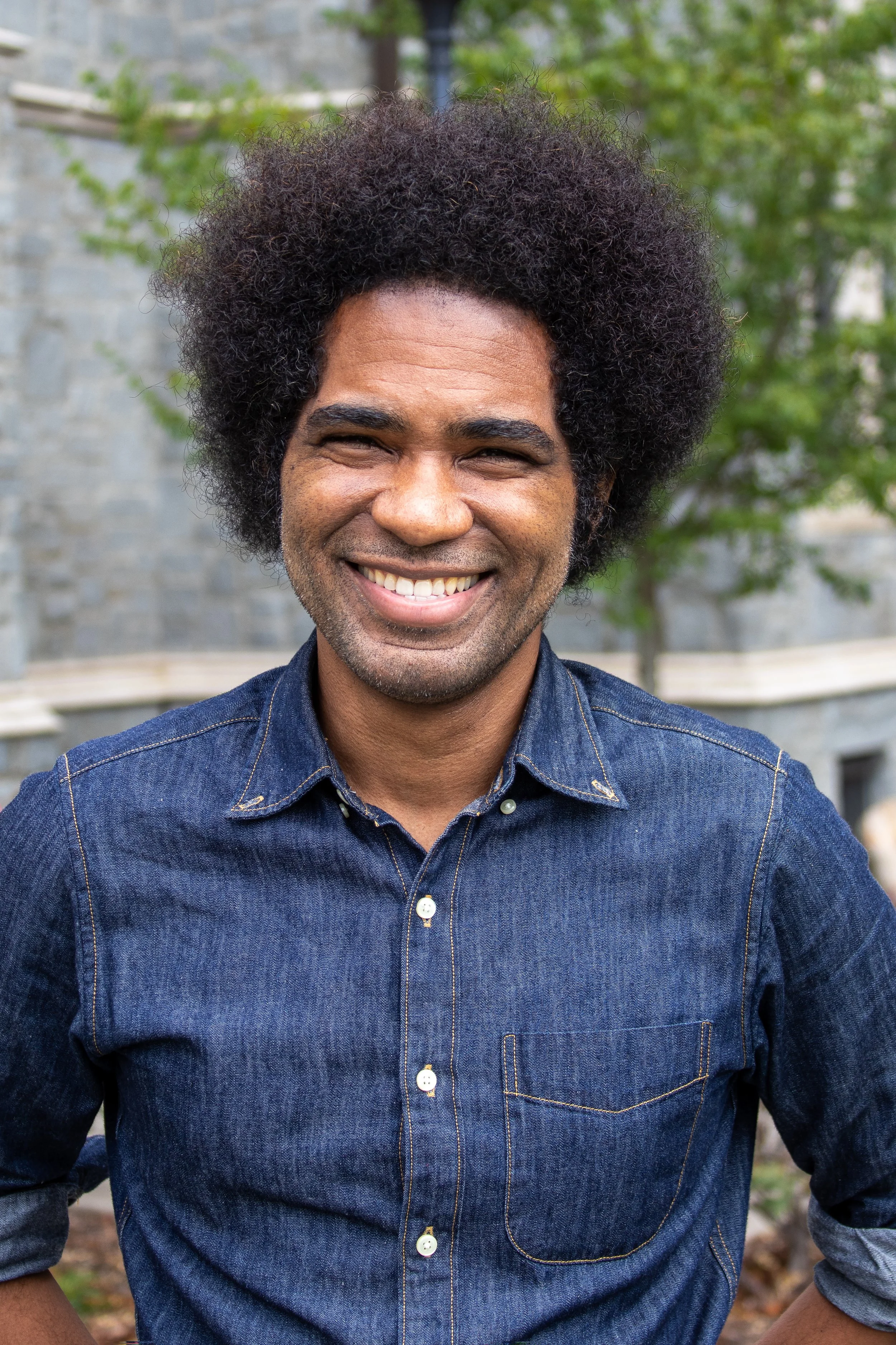 Justin Haynes standing in front of a gray and white building.