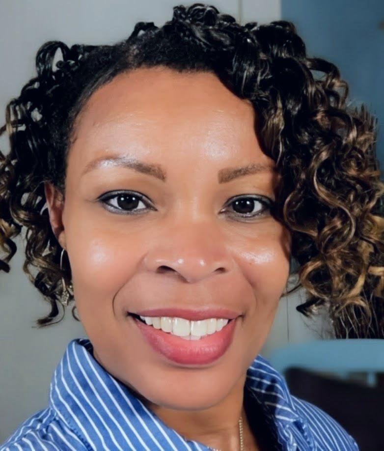 Tonya Richardson standing in front of a blue and white wall.