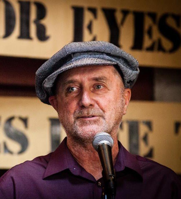 Rupert Fike standing in front of a microphone.